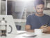 Man texting with cell phone at kitchen table